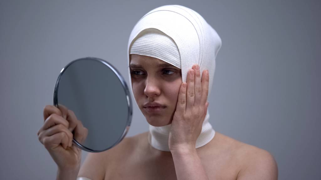 woman in head wrap after facelift operation